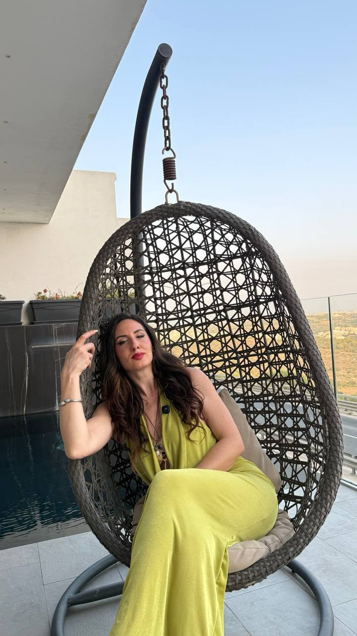 Samantha seduta su una poltrona sospesa in terrazza